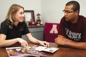 An admissions advisor speaking with a student about our viewbook.